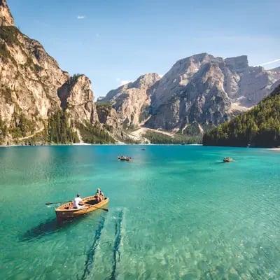 Barca su un lago turchese circondato dalle montagne